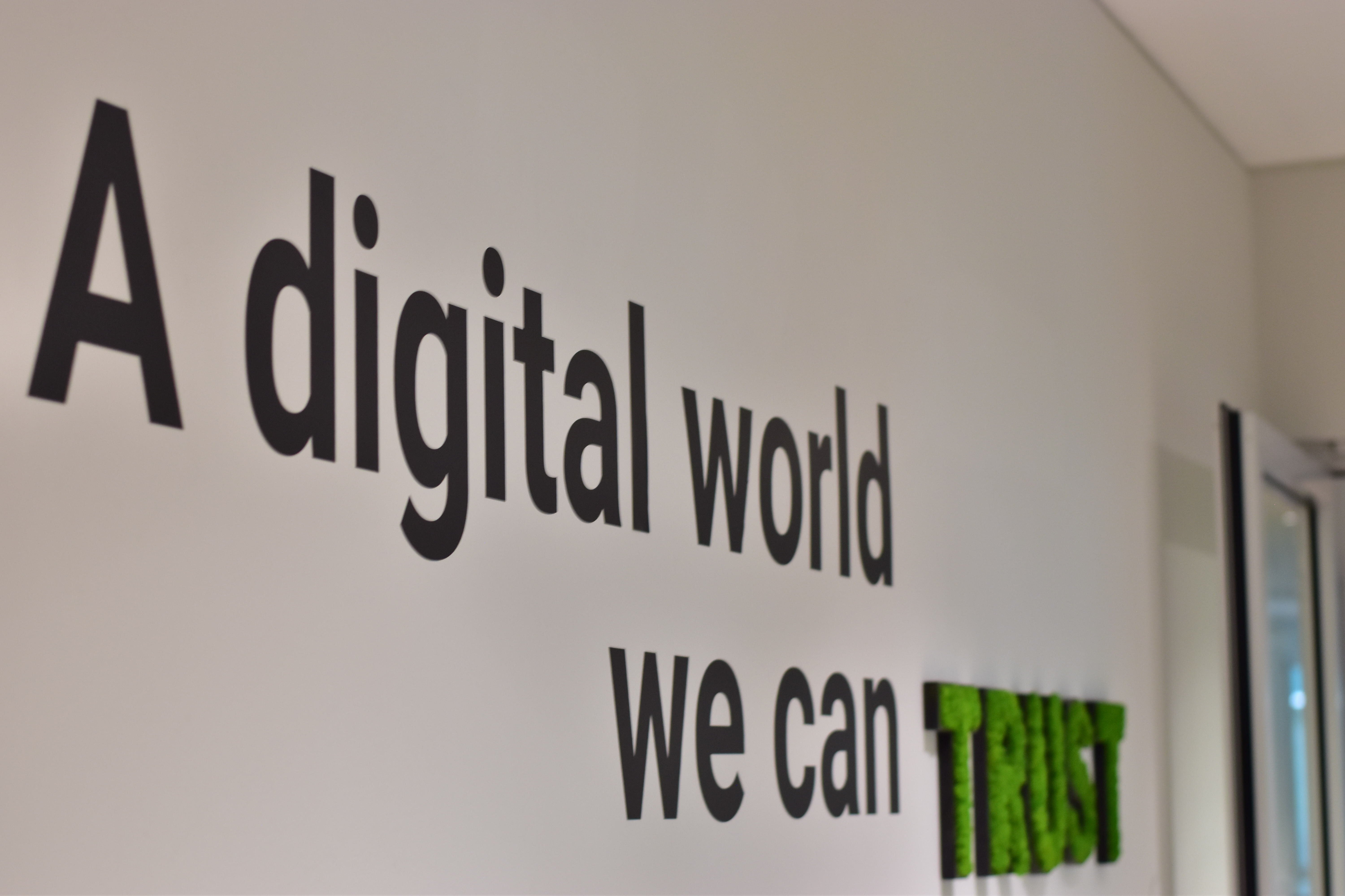 A photograph from the Trusted Shops office with the slogan ‘A digital world you can trust’ on the wall.