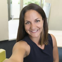 Female Trusted Shops employee smiles for a Selfie.